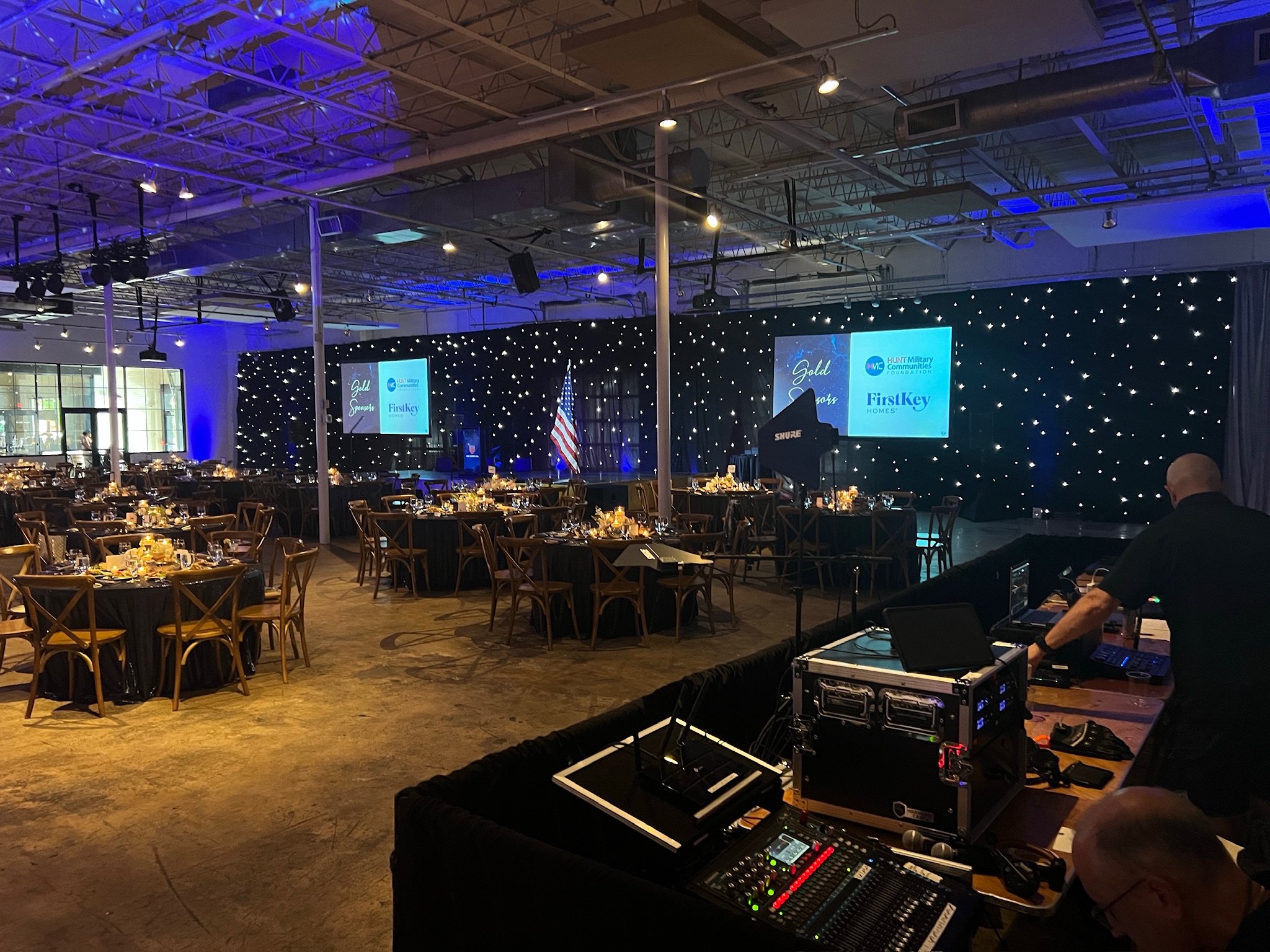 Teleprompting support at an upscale gala ballroom event with stage screens and uplighting