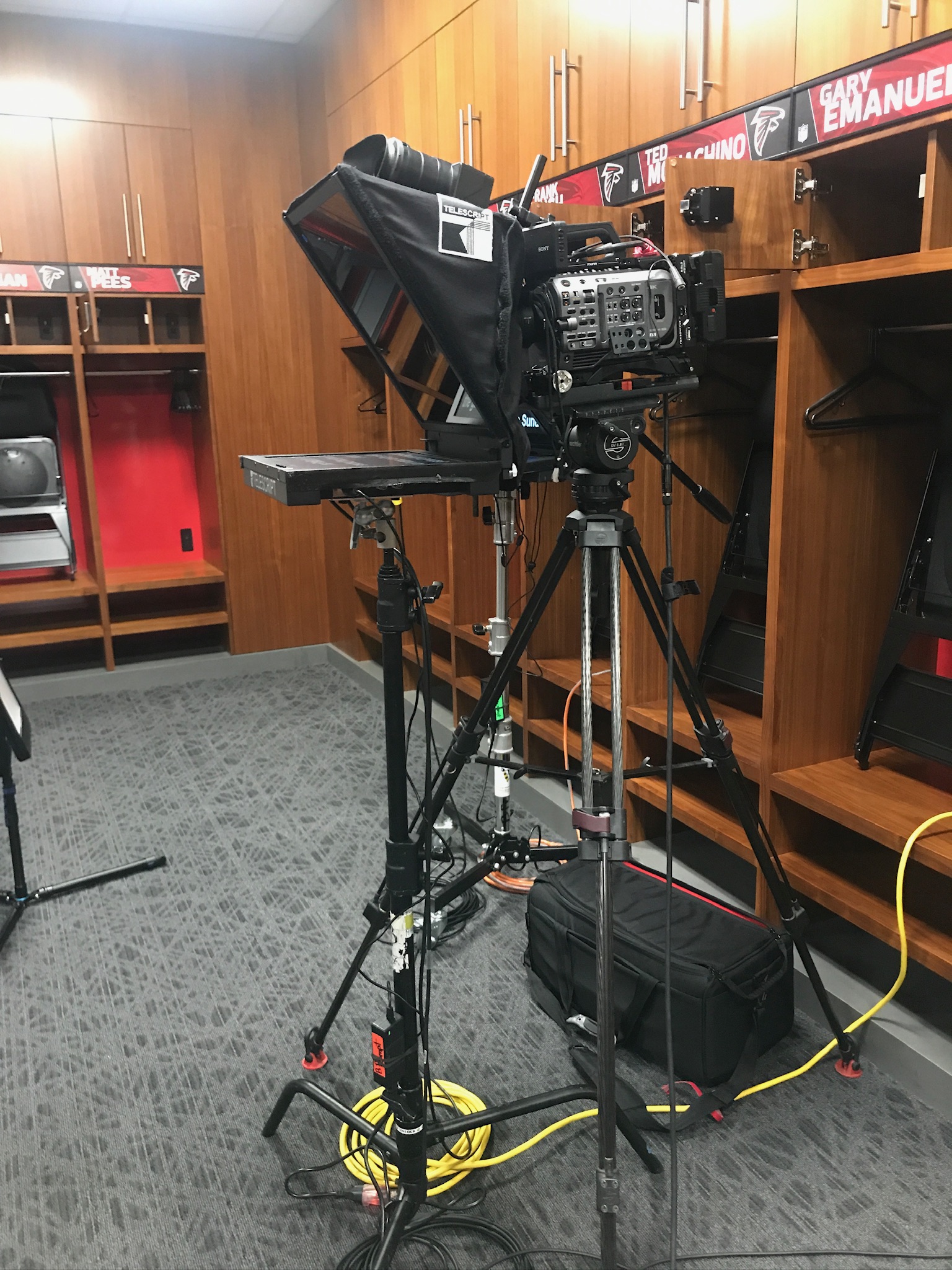 Teleprompter and cinema camera setup inside an NFL locker room shoot
